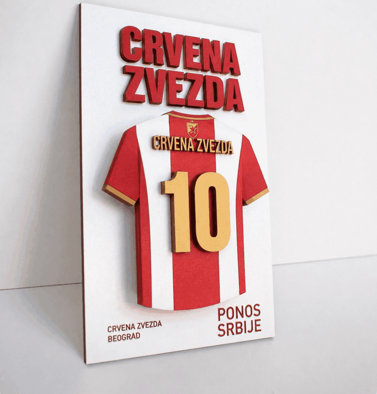3D wall art featuring a red and white Crvena Zvezda football jersey with number 10, raised lettering, and gold details on a white background.